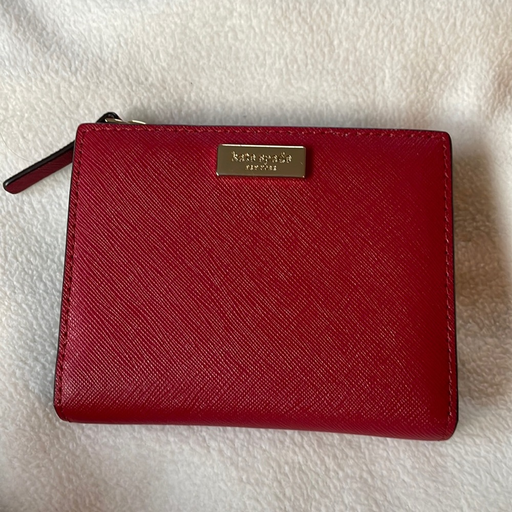kate Spade. Cherry red wallet hold 6 cards and has zipper compartment.